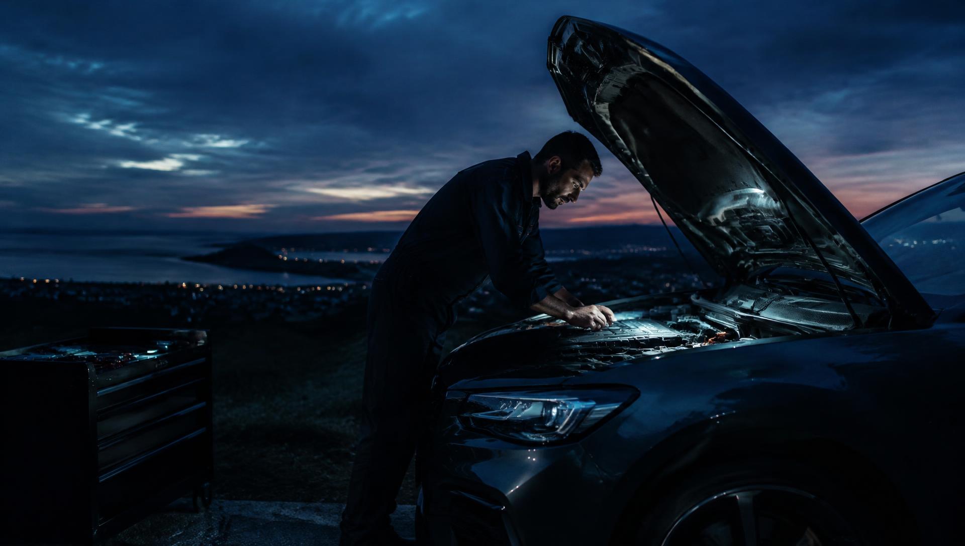 Mechanic working under a vehicle bonnet